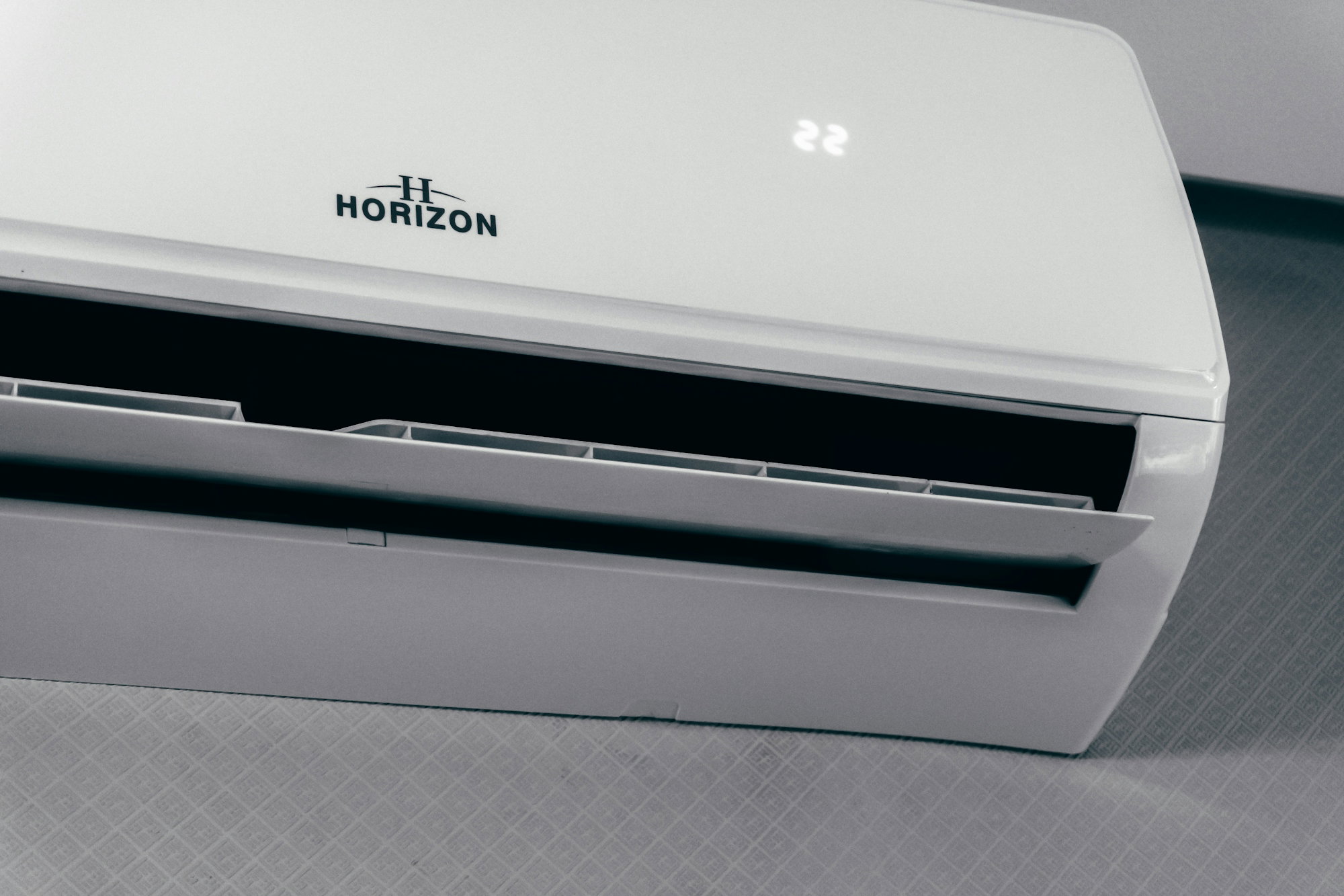 white-air-conditioner-unit-displaying-22-degrees.jpg White air conditioner unit displaying 22 degrees